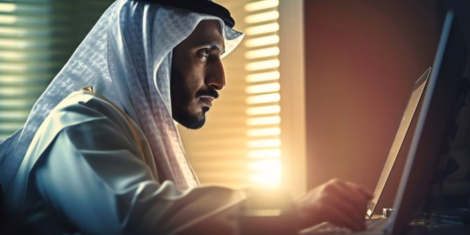 saudi-business-man-using-laptop-office
